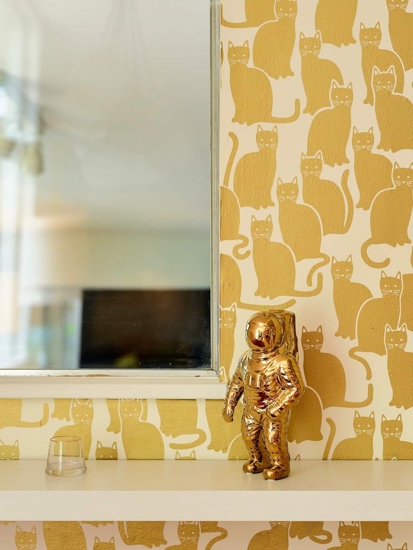 Dining room detail with glass table and pink shag rug