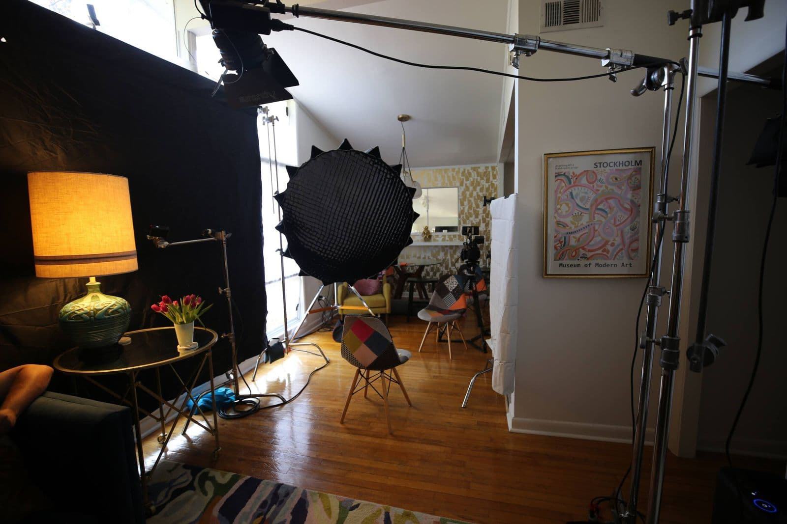 Studio lights and a backdrop set up in the living room